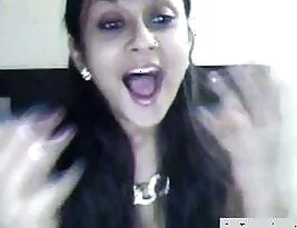 A sexy NRI wife (bhabhi) in action while pleasuring herself on webcam for her lover.