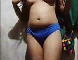 A young Indian woman exposes her breasts and vagina.