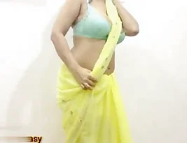 A middle aged Indian woman in a yellow saree seductively dances and have sex with her lover.