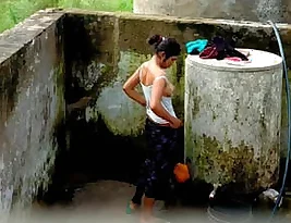 Pretty Indian girl is standing in the bathroom doorway