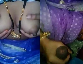 Married woman Lalita Singh showing her large breasts while giving a handjob to her husband s penis.