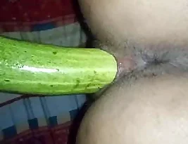 My wife is moaning while I am fucking her with a big cucumber like an Indian housewife