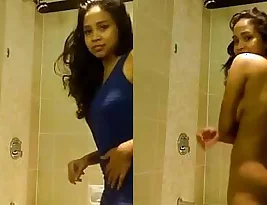 Young Indian girl in the bathroom shows her body