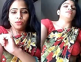 Beautiful woman wearing a saree, exposing her belly button.