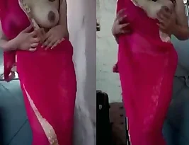 An Indian house wife Showing her big Boobs in a red dress for her husband.