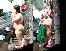 Hidden camera captures Desi Bhabhi bathing outside in a secret room.