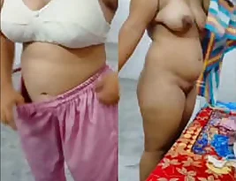 The wife of a Desi man changes her clothes after having sex in front of the camera.