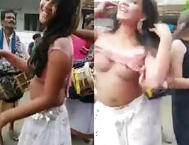 Naked dancers on the street in a small village attract people’s attention.