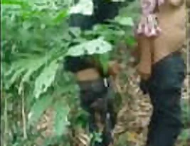 A woman from an Indian village having a sex with a black man in the woods.