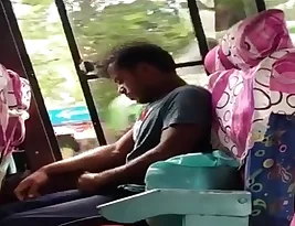 A person from Tarki is pleasuring himself in a bus and he is aware that the girls who are sitting next to him are filming him.