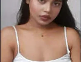 A Indian woman with large breasts has part of the vagina shown.