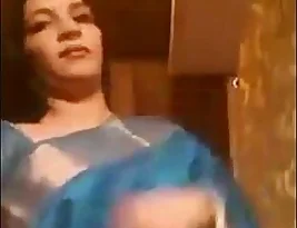 An Indian woman in her prime stripping off her garment.